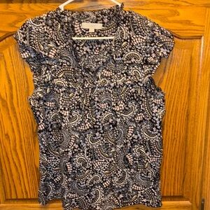 Patterned Black/white/pink pattern top. Ruffle sleeve and tie neck detail